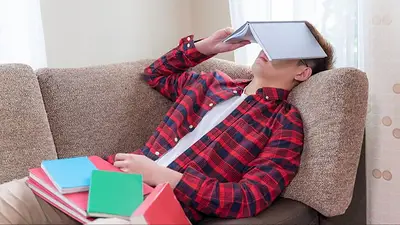 Un chico con cuadernos en la cara Un chico con cuadernos en la cara