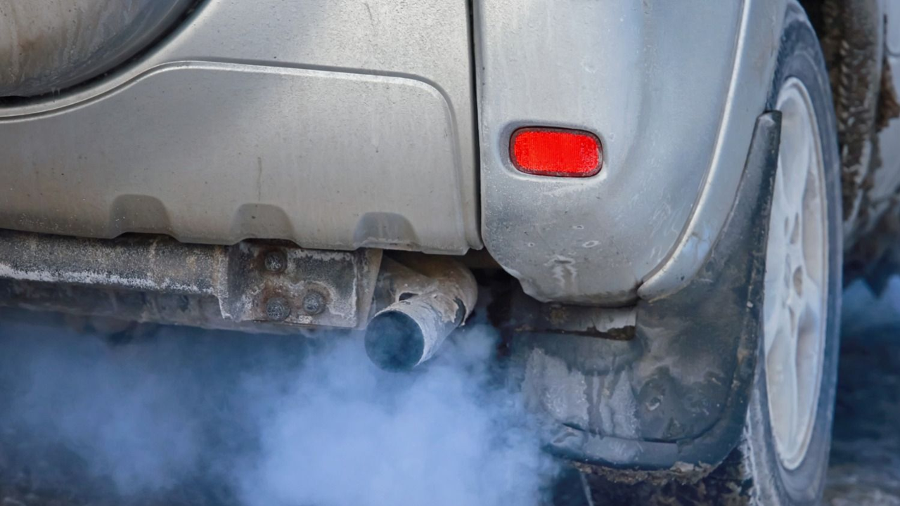 Auto humo azul del caño de escape y significado