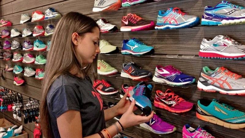 Consumidora mirando zapatillas para comprar en un outlet