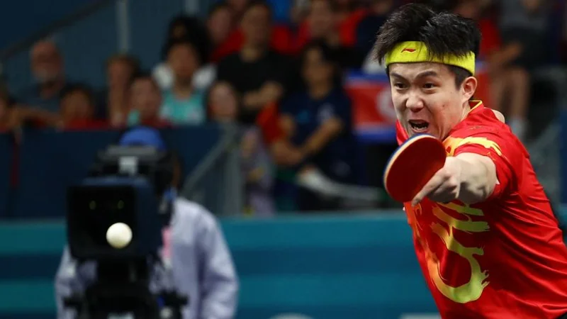 La alegría del medallista de oro chino Wang se ve truncada por un accidente con su paleta