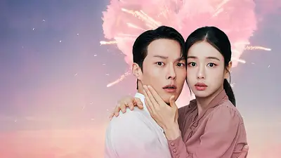 Protagonistas de serie se abrazan, atrás un corazón rosa de explosivos Protagonistas de serie se abrazan, atrás un corazón rosa de explosivos