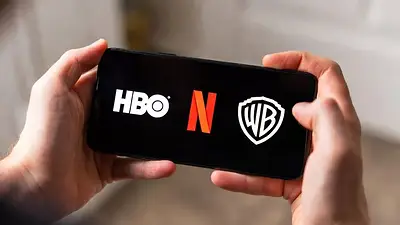 Teléfono muestra logos de Warner, HBO y Netflix. Teléfono muestra logos de Warner, HBO y Netflix.