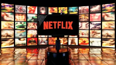 Teléfono con Netflix y al fondo pantallas Teléfono con Netflix y al fondo pantallas